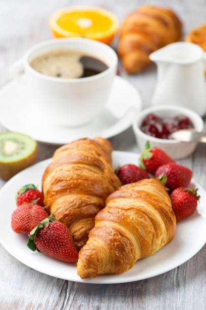 istock Continental breakfast table with coffee, orange juice, croissants 1140123980
