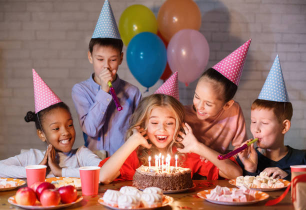 istock Kids looking at birthday cake with candles 1140124217