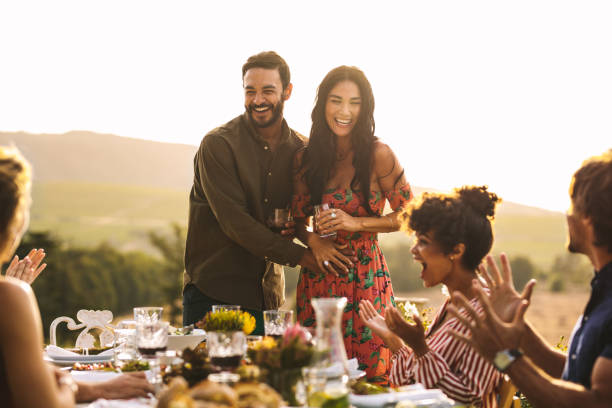 istock Excited couple announcing their pregnancy at a party 1140124855