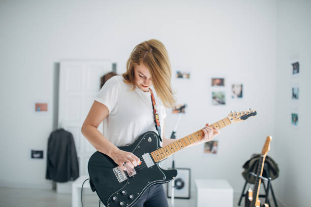 istock Charming lady playing electric guitar 1140125151