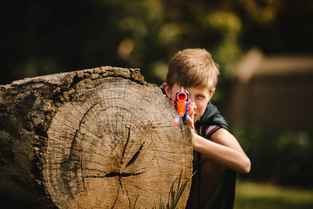 istock Boy playing with toy gun in playground. 1140126232