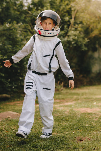 istock Kid playing in astronaut suit outdoors 1140126336