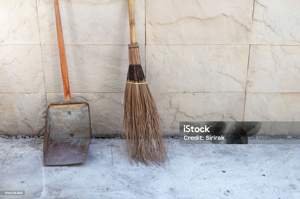 Bamboo Broom Stick And Old Metal Dust Pan For Outdoor Cleaning Stock Photo  - Download Image Now - iStock