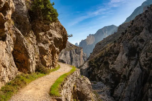 Photo of Route Cares River Gorge (Cain-Poncebos). Narrow and impressive canyon between cliffs, bridges, caves, footpaths and rocky mountains. Perfect place for hiking. Picos de Europa, Leon and Asturias, Spain