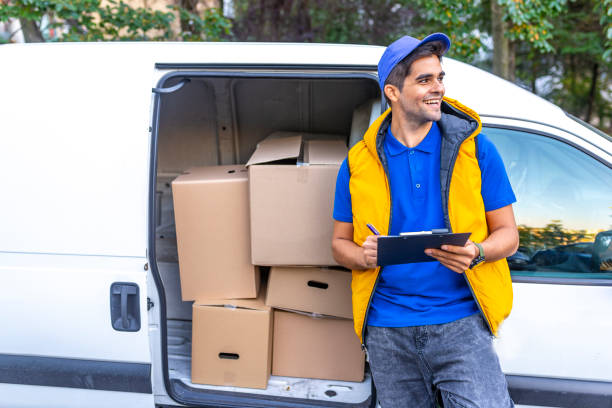 istock Young male deliverer noting executing of order 1140126849