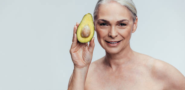 istock Elderly woman showing an avocado 1140127289