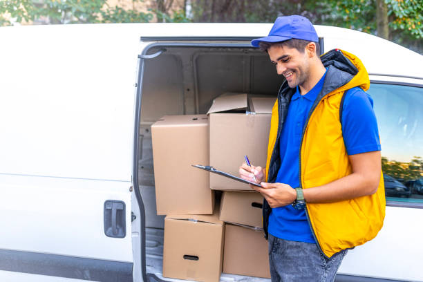 istock Young male deliverer noting executing of order 1140127829