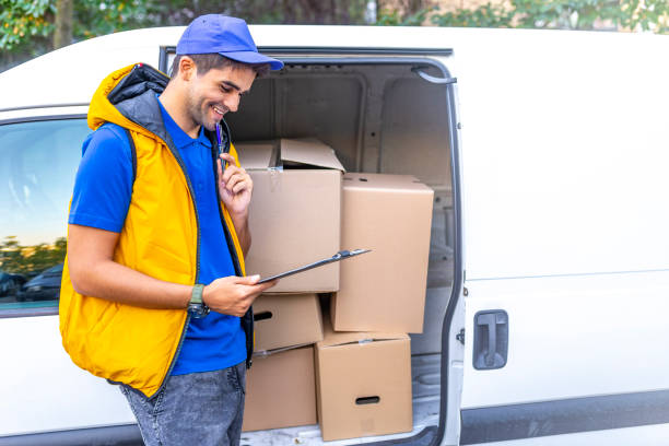 istock Young male deliverer noting executing of order 1140127835