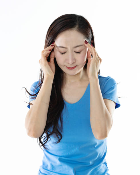istock Woman with headache on white background 1140127938