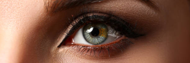 istock Female left emerald green coloured eye extreme closeup 1140129400