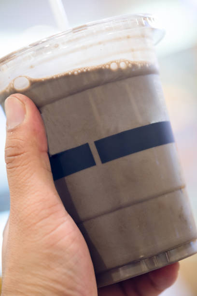 istock Hojicha ice tea in cup in hand 1140132737