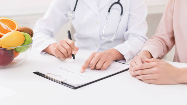 istock Doctor nutritionist and patient discussing diet plan 1140134128
