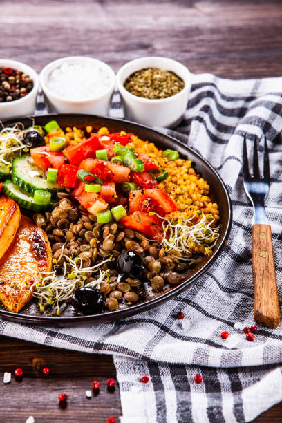 istock Groats and vegetables on wooden table 1140134461