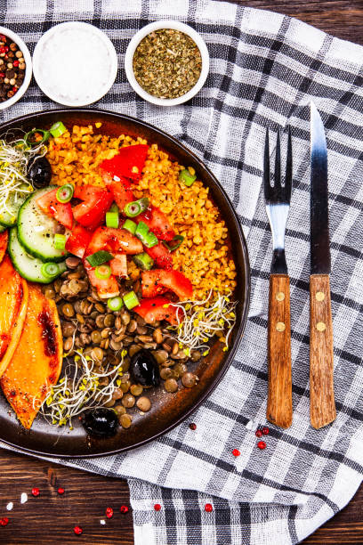 istock Groats and vegetables on wooden table 1140134666