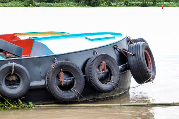 istock Tug boat with tires fender on the river 1140135530