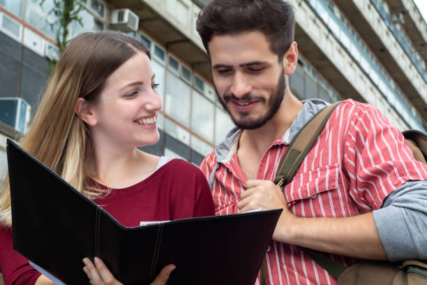 istock Two University students studying together outdoors 1140135595