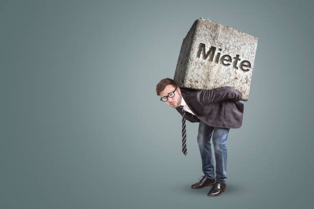 istock Man carrying a heavy stone with the German word 
