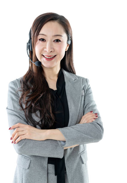 istock Smiling woman wearing a phone headset on white background 1140136255