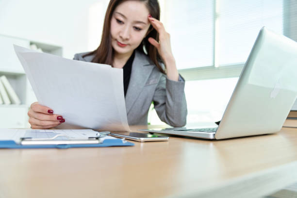 istock Businesswoman doing paperwork in office 1140137086