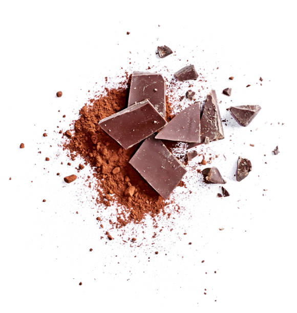 Cocoa powder and pieces of dark chocolate Cocoa powder and pieces of dark chocolate, isolated on white background. Cake ingredients, top view or high angle shot. dark chocolate stock pictures, royalty-free photos & images
