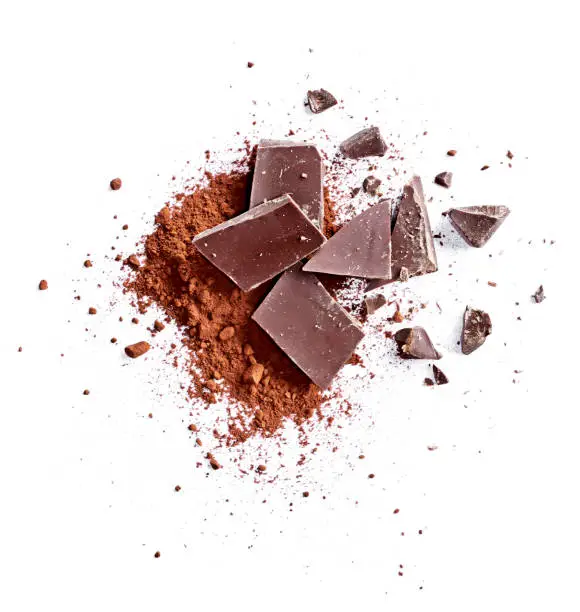 Cocoa powder and pieces of dark chocolate, isolated on white background. Cake ingredients, top view or high angle shot.