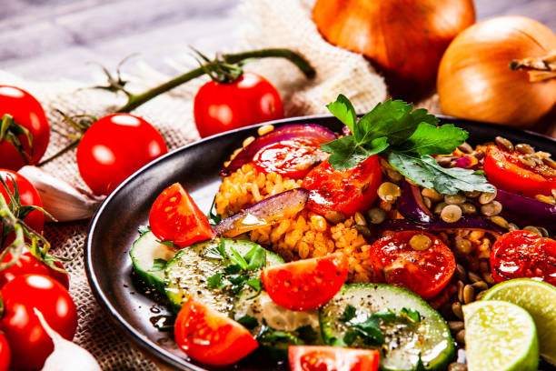 istock Groats and vegetables on wooden table 1140137675