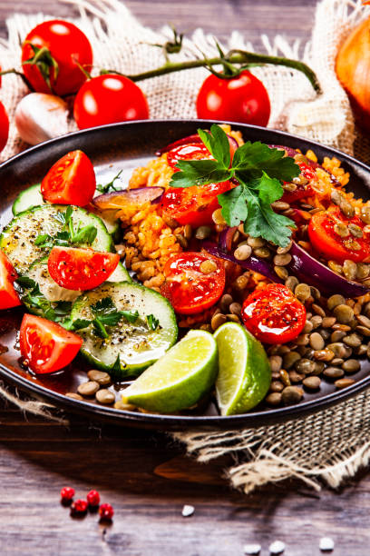 istock Groats and vegetables on wooden table 1140137696