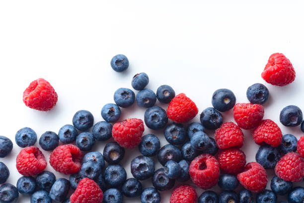 istock Raspberries and blueberries isolated on white background with copy space 1140137977