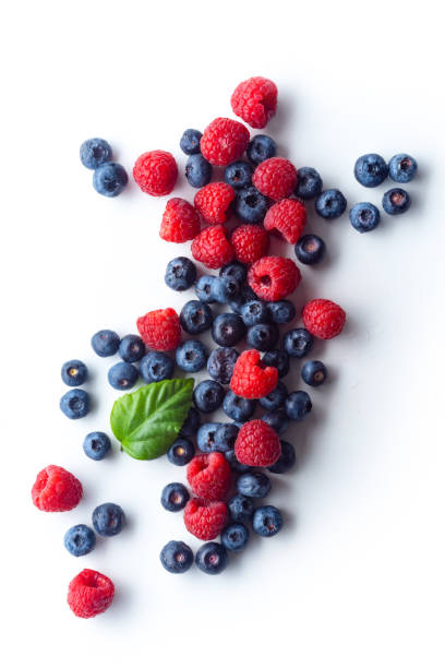 istock Raspberries and blueberries isolated on white background with copy space 1140138000