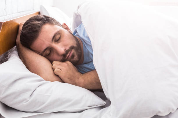istock Handsome man sleeping in bed at home 1140138758