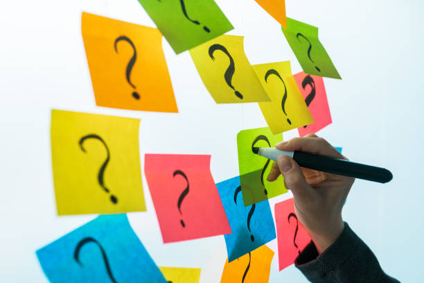 istock Businesswoman writing question marks on colorful sticky note paper 1140138831