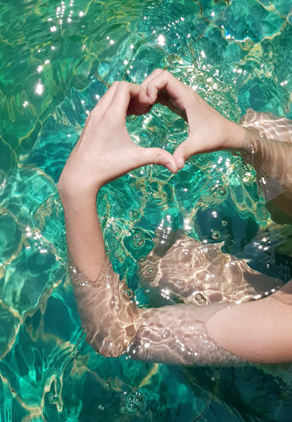 istock heart shape hands in the pool 1140138876