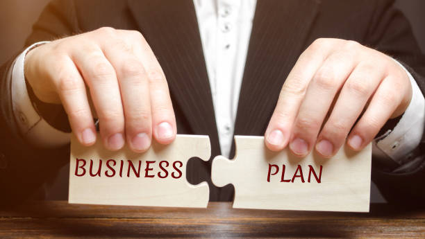 istock Businessman collects puzzles with the word Business Plan. Business operations program. Organization and management of processes and increase their efficiency. Action plan. Achievement of goals 1140138879