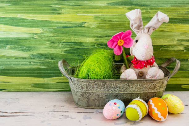 istock Easter concept - rabbit in front of green background 1140138985