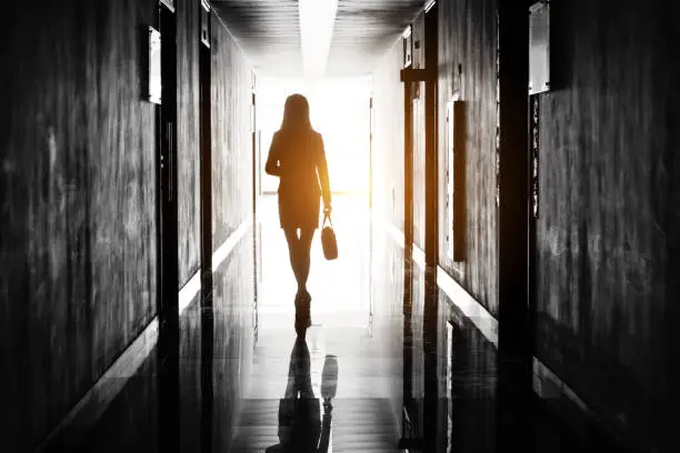 Businesswoman through the office corridor.