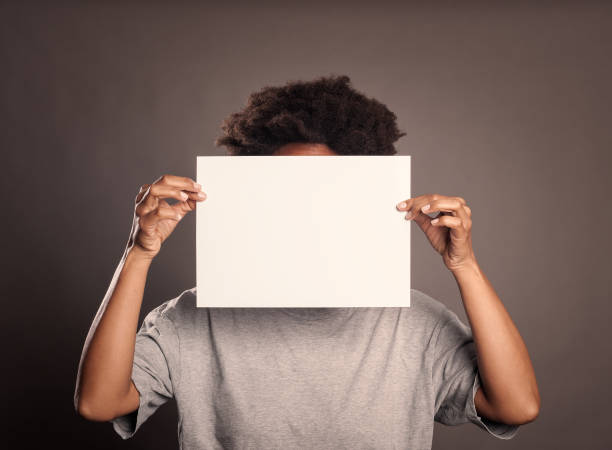 istock woman holding an empty banner 1140140422