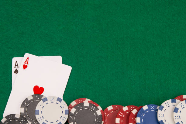 istock on the green table, two aces and scattered blackjack chips, on the right there is a place for the inscription 1140142359