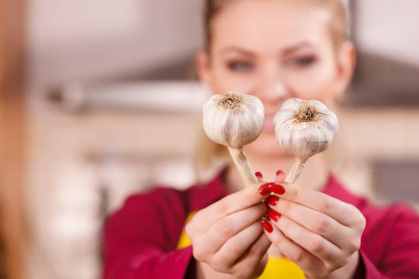 istock Woman holding two garlic 1140143030