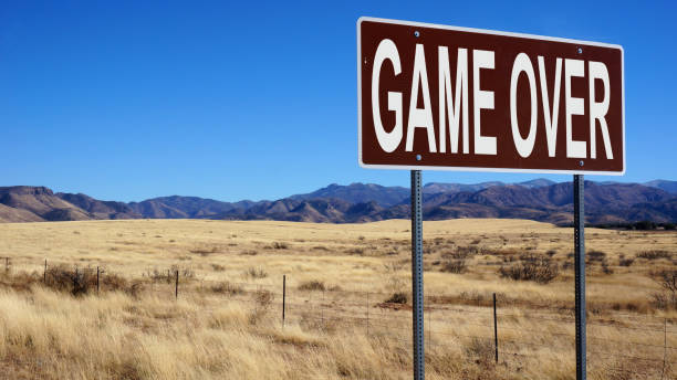 istock Game over word on road sign and blue sky 1140143112