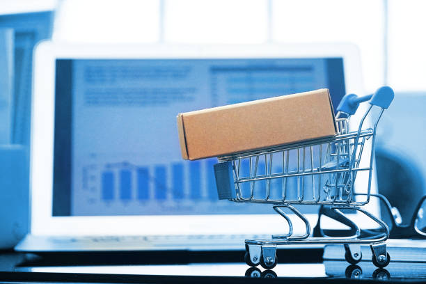 istock Packaging box on shopping cart with background computer screen , online shopping concept. 1140143965