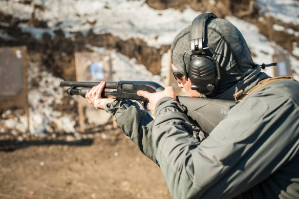 istock Tactical combat pump gun shooting training. Shotgun weapon action course 1140144836