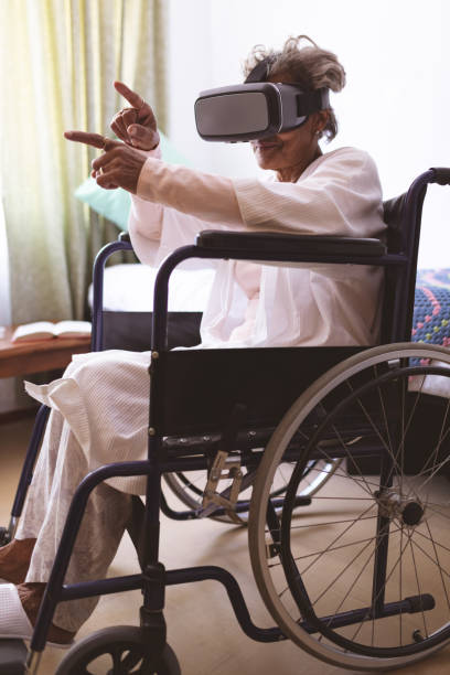 istock Senior woman using virtual realty headset at nursing home 1140148509