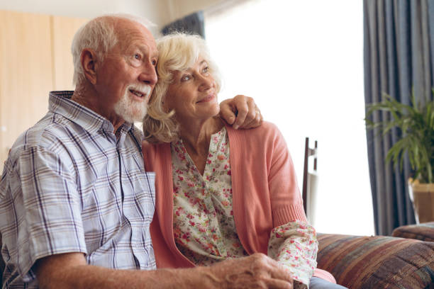 istock Senior couple sitting and posing on sofa at retirement home 1140149220