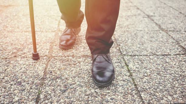 Old man walking in the park Old man walking in the park walking stick stock pictures, royalty-free photos & images