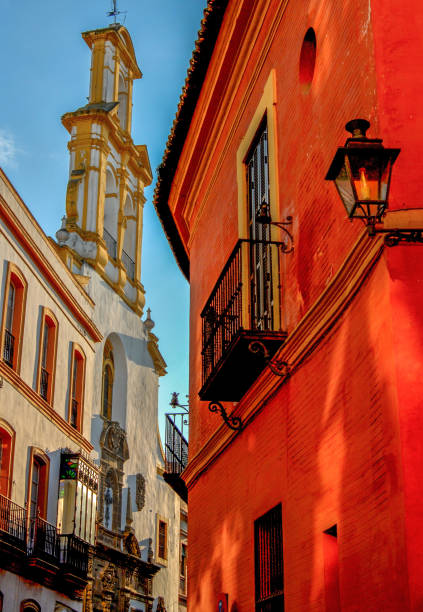 A narrow street in Andalusi's capital Seville,featuring Santa Cruz church,