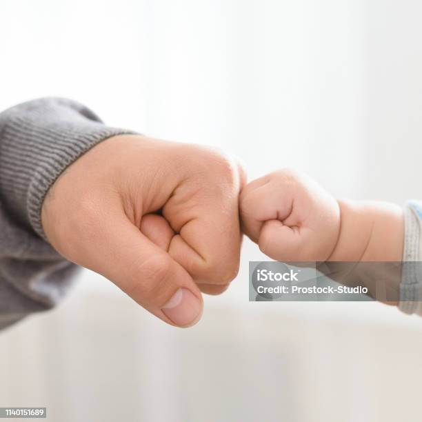 Close Up Of Father Holding Baby Hand Stock Photo - Download Image Now - Father, Baby - Human Age, Hand