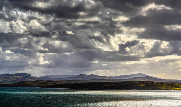 Falkland Islands, sun shining through dramatic clouds cloudscape in the south allantic,the weather is frequently unsettled and turbulent in this part of the world. falkland islands stock pictures, royalty-free photos & images