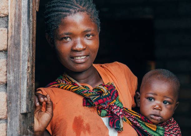 African Mother with Baby Son at Home African Mother with Baby Son at Home malawi stock pictures, royalty-free photos & images