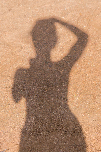 Shadow of the person with reflection on the ground - Image