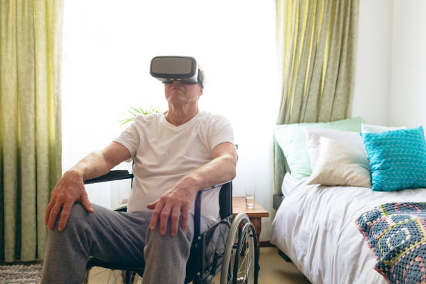 istock Senior male patient using virtual reality headset at retirement home 1140154354